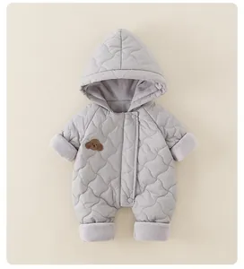 Détail d'une combinaison bébé matelassée avec broderie chien et doublure peluche