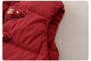 Detail of red quilted down vest with Fu character embroidery for festive baby clothing
