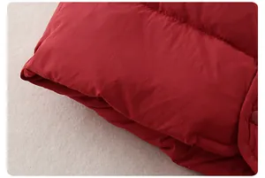 Detail of red quilted down vest fabric with premium snap button and waterproof texture