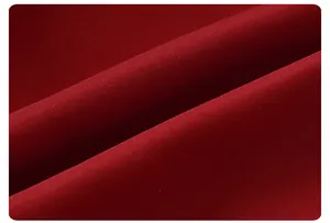 Macro view of the red fabric texture and twill weaving on this warm baby down vest