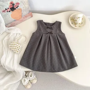 Sweet winter dress for baby girls featuring grey polka dot pattern and soft bow accents