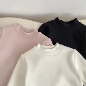 Detailed view of three thick fleece-lined thermal tops in pink, black, and white colors