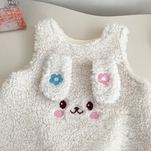 Detail of baby winter vest with cute 3D bunny ears and delicate floral embroidery