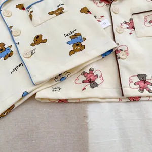 Detailed view of soft cotton baby pajama sets featuring cute bear and dog prints