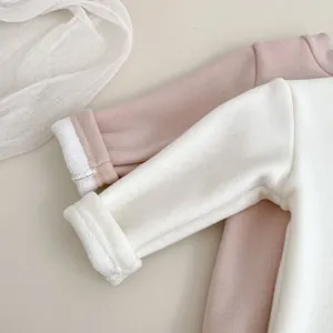 Detail of soft fleece lining and folded cuffs on children's thick cotton shirts
