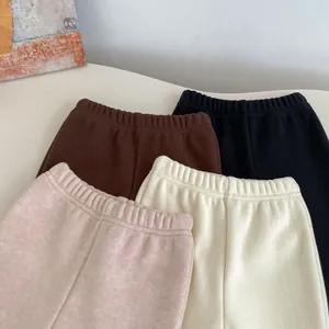 Close-up of winter fleece-lined flare pants for girls in four soft assorted colors