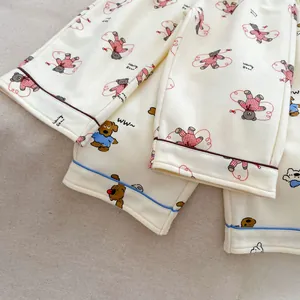 Detail of soft cotton kids pajama pants featuring cute bear prints and cuffed hems