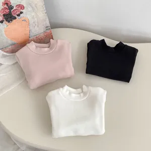 Flat lay of pink, black, and white fleece-lined thermal long-sleeve T-shirts for kids