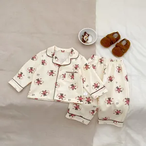 Close-up of baby pajama set with red bear print and size 73 label on white fabric