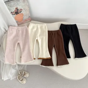 Close-up of girls' ribbed flare leggings with delicate white lace trim in four colors