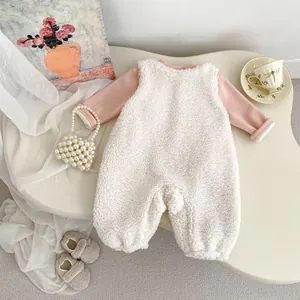 Detail of pink cotton baby top and white fleece romper set for winter comfort