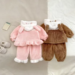 Detailed close-up of thick pink and brown flannel pajama sets for babies with animal hoods