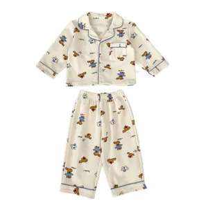 Cute beige long-sleeved cartoon puppy baby pajama set with button-up top and trousers