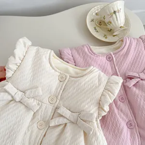 Detail of baby quilted vest featuring bubble texture fabric and cute bow decorations