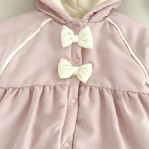 Detail eines rosa Baby-Stramplers mit weißen 3D-Schleifen und weichem Steppstoff