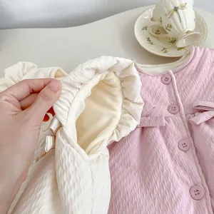Quilted toddler vest in pink and cream with warm fleece lining and bow details