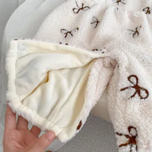 Winter fleece baby romper set in cream white with brown bow embroidery and snap buttons