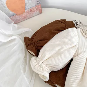 Detailed view of kids corduroy coats with elegant lace collars and elastic puff sleeves