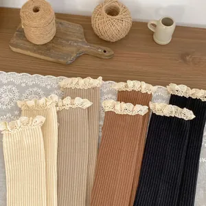 Flat lay of vintage cotton socks with double-layered lace edges in four earthy colors