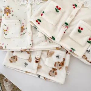 Detailweergave van fleece babypyjama's met kantkragen en diverse dierenprints