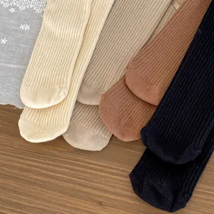 Detailed knit texture of children's cotton ribbed socks in four earth-tone colors