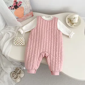 Detailed view of pink quilted newborn romper with white sleeves and ribbed ankle cuffs