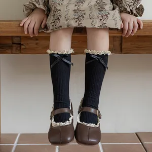 Retro girls' black mid-calf cotton socks with white lace trim and silk bows