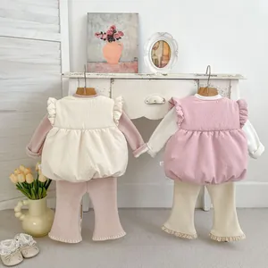 Detail of baby girl waffle knit 3-piece set with ruffle vest and lace hem pants