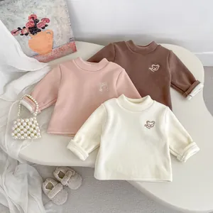 Detail of three thermal fleece sweatshirts for kids featuring cute bear embroidery accents