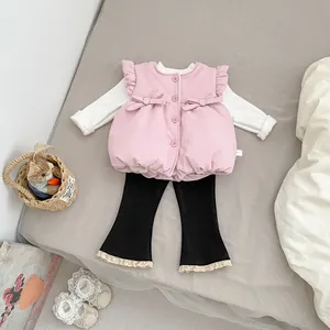 Detailed view of baby girl quilted pink vest with bow accents and lace hem flared pants
