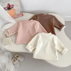 Close-up of three fleece-lined thermal shirts in pink, brown and white colors