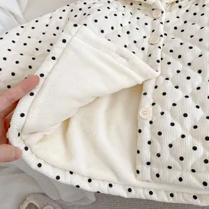 Quilted winter jacket for toddlers with polka dots and warm fleece lining shown in detail