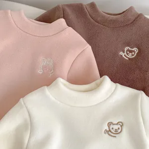 Detailed view of fleece thermal tops with cute bear embroidery in three warm colors