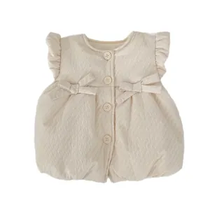 Quilted toddler vest in cream white with ruffled shoulders and bow accents
