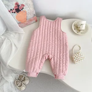 Detail of pink quilted baby sleepsuit with soft vertical stitching and warm texture