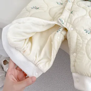 Floral quilted baby romper with warm fleece lining and elegant floral embroidery