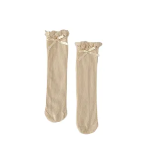 Creamy beige girls' cotton socks featuring elegant lace trim and ribbon bows