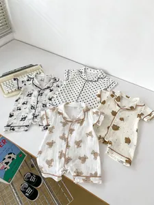 Flat lay of baby short sleeve cotton rompers with cute panda and bear cartoon patterns