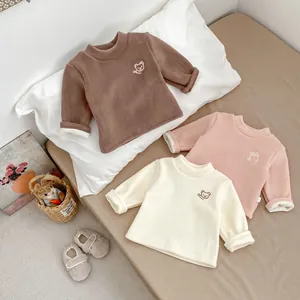 Detailed view of kids thermal fleece tops featuring cute bear embroidery and soft texture