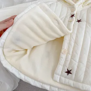 Detail der weißen gesteppten Baby-Winterjacke mit Sternenstickerei und Fleece-Futter