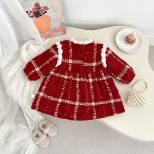 Detail of red tweed Christmas dress featuring white faux fur trim and gold button accents