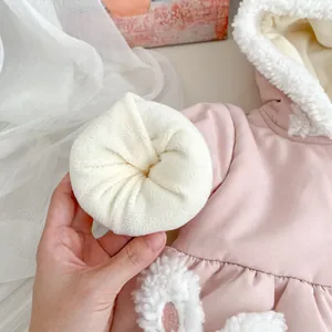 Detail of baby girl pink winter coat showing thick white fleece lining and warm soft texture