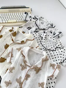 Detail of baby summer gauze cotton rompers with cute cartoon bear and panda prints