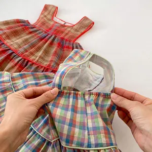 Close-up of baby girl plaid tank top set showing quality cotton fabric and piping detail