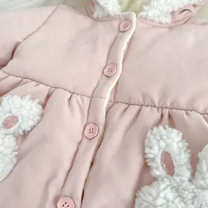 Close-up of pink winter coat featuring plush sherpa lining and cute bunny ear details