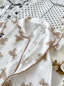 Close-up of baby romper showing breathable cotton gauze texture and cute bear pattern