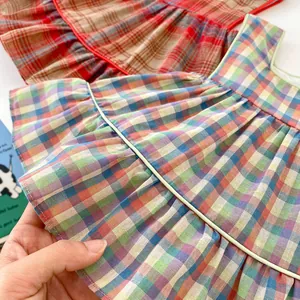 Detail view of cotton plaid fabric with colorful checks and ruffle hem for girls