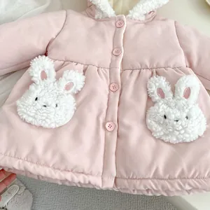 Close-up of pink toddler winter coat featuring 3D bunny pockets and white fleece lining