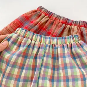 Close-up of girls' breathable plaid cotton shorts featuring elastic waist and vibrant checks