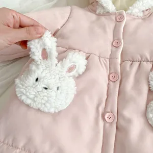 Pink quilted winter coat for girls with cute plush rabbit pockets and flower buttons